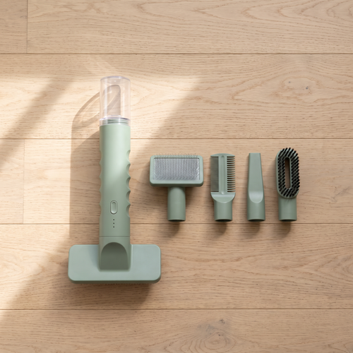 Top-down flat lay of the Apollochi grooming vacuum wand with its detachable attachment heads laid out on Australian timber floorboards